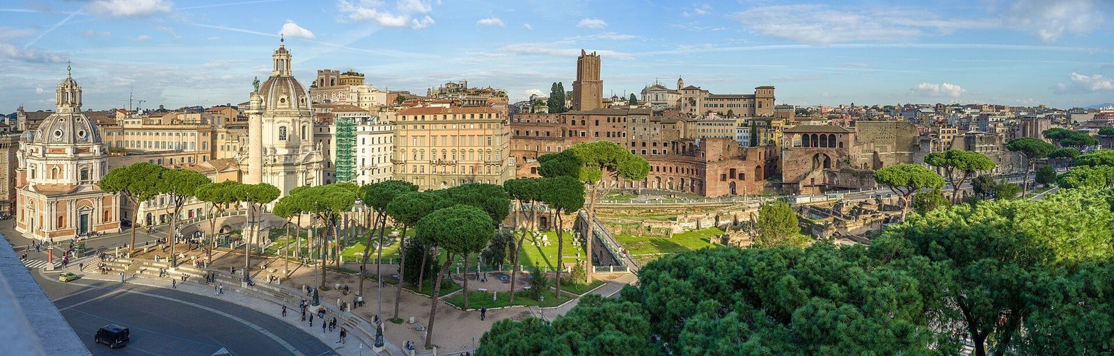 Trajan's Forum in Rome seen from the Vittoriano: the column and ruined forum square set among the churches, domes and umbrella pines of the city
