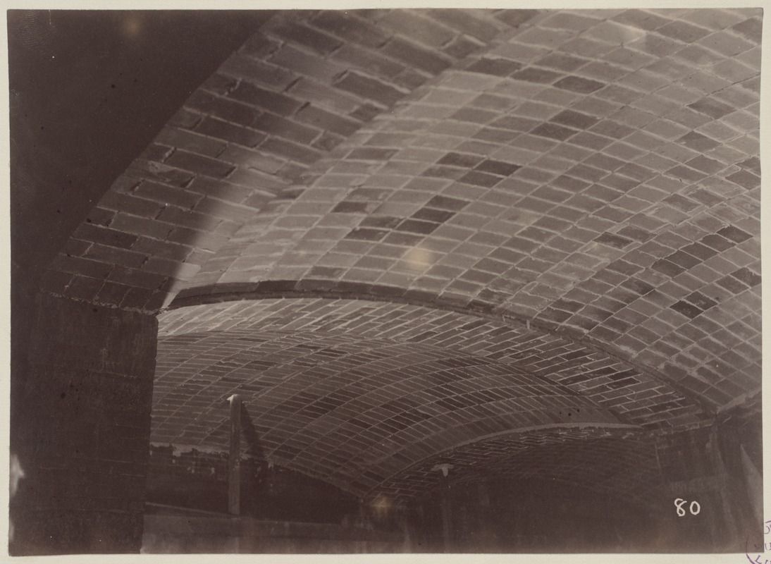 Guastavino timbrel tile vaults under construction in the basement of the McKim Building, Boston Public Library — the unreinforced masonry-shell craft that today's parametric vault builders revive