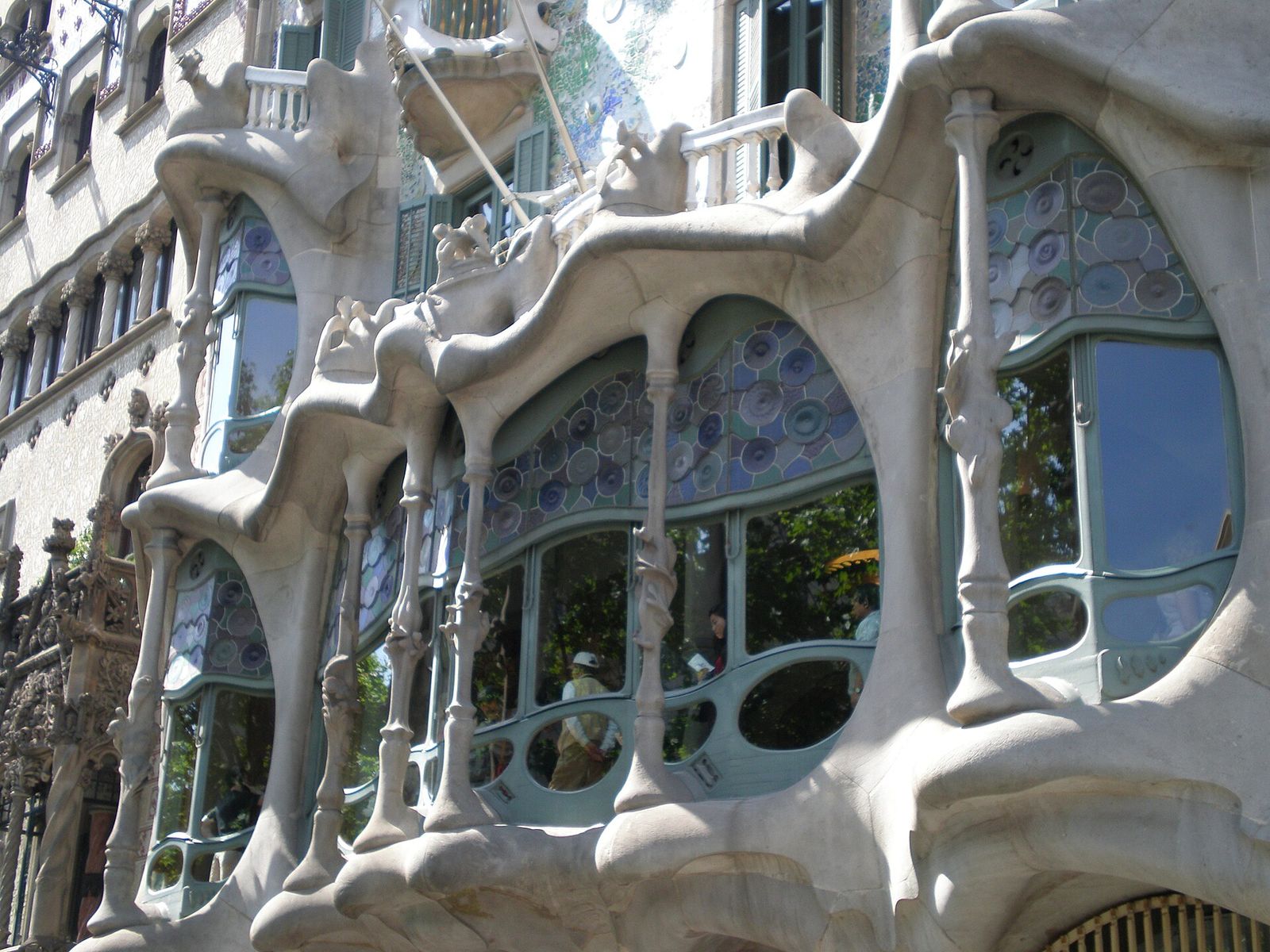 The undulating facade of Casa Batlló in Barcelona, with mask-like balconies and mosaic tile