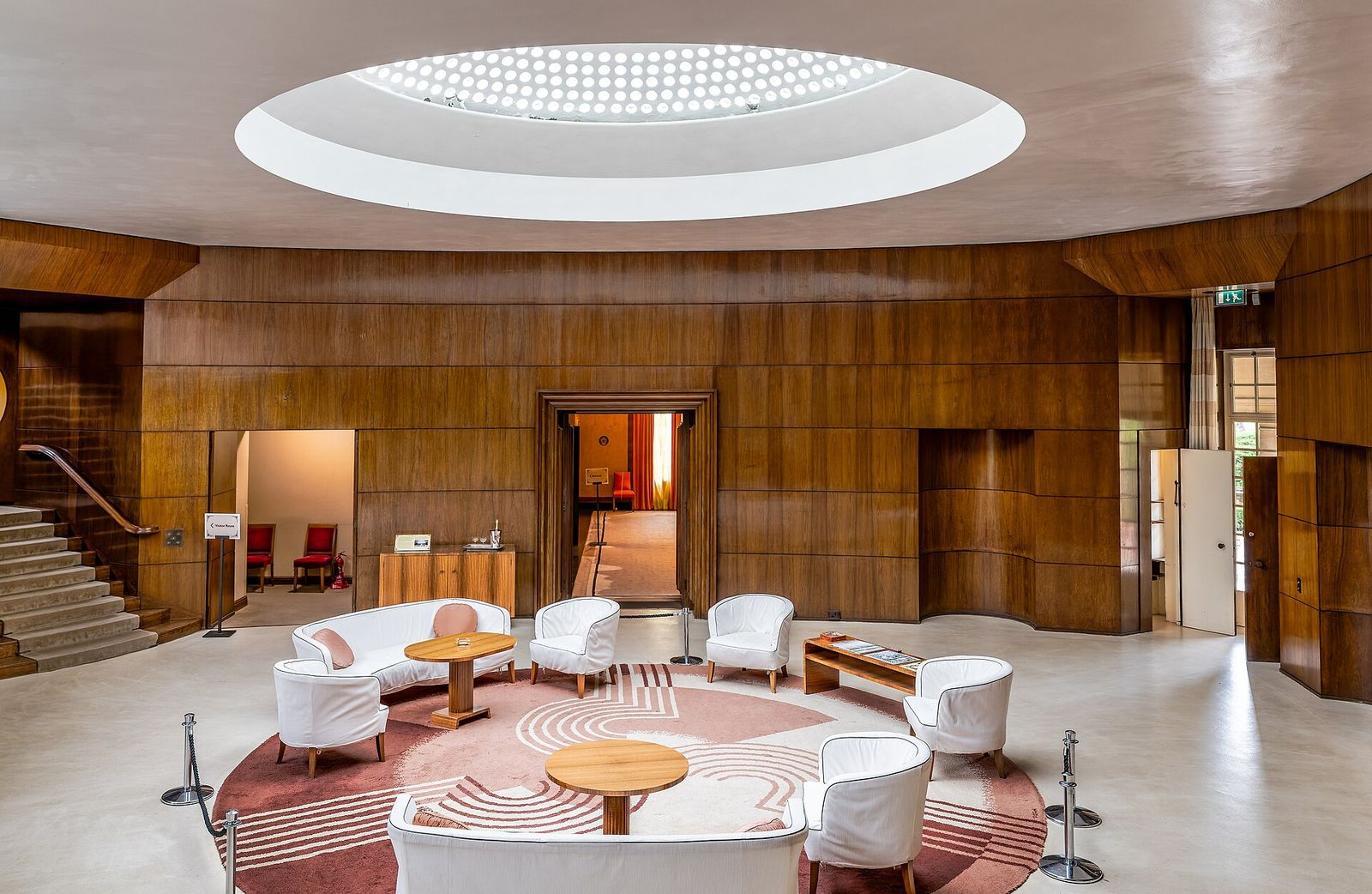 The circular entrance hall of Eltham Palace in London, wood-panelled under its glazed dome