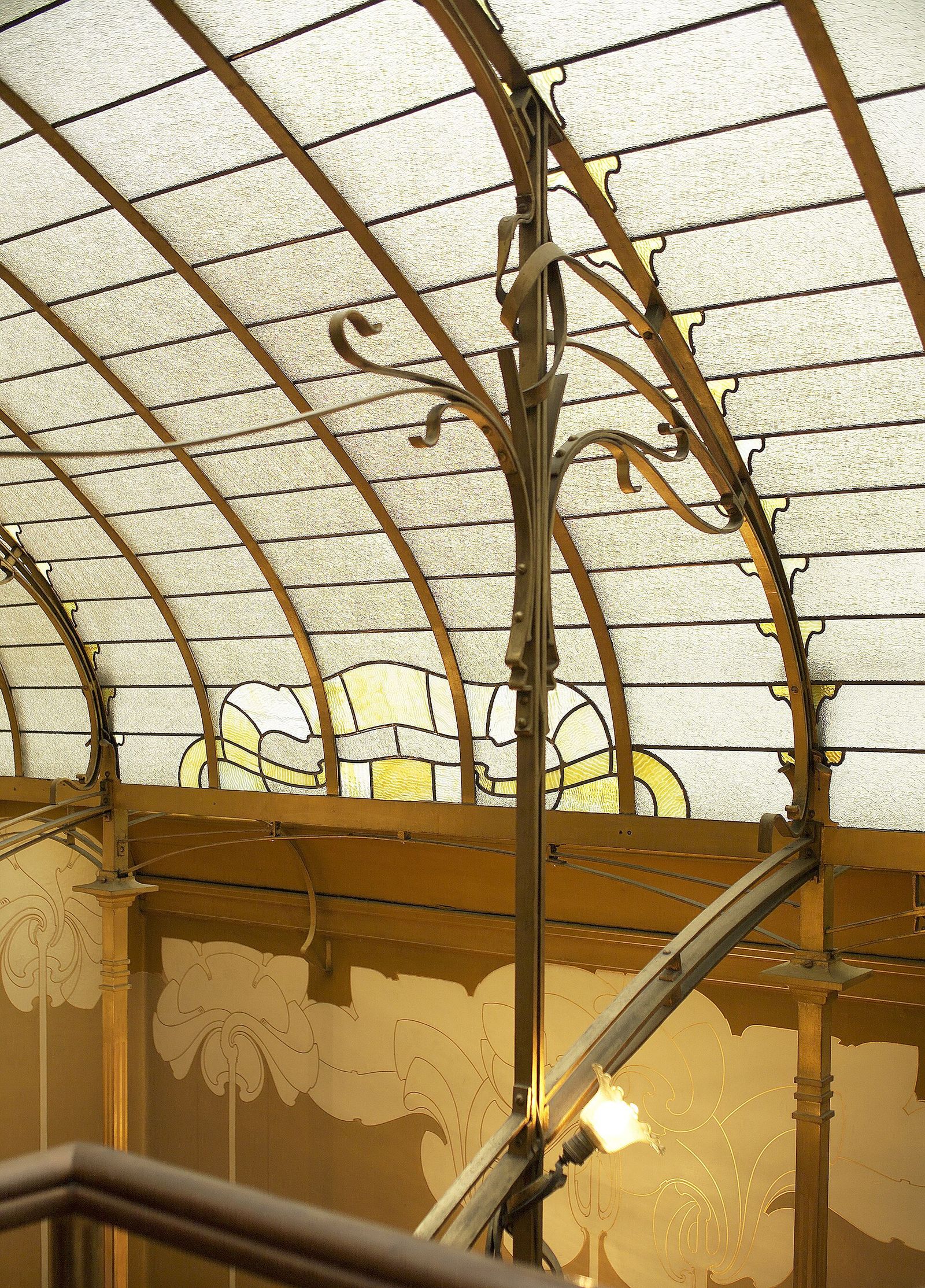 The top-lit staircase of Victor Horta's own house in Brussels, now the Horta Museum, with its sinuous iron railing and stained-glass skylight