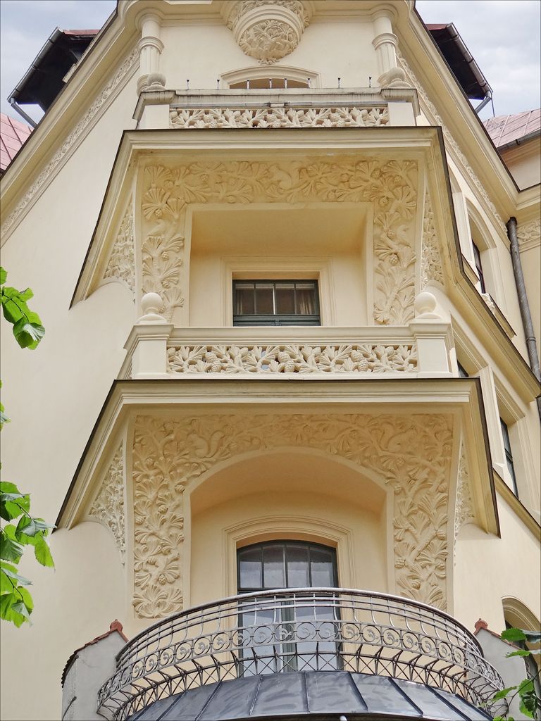 An ornamented Art Nouveau facade on Alberta iela in Riga, its balconies carved with masks and garlands