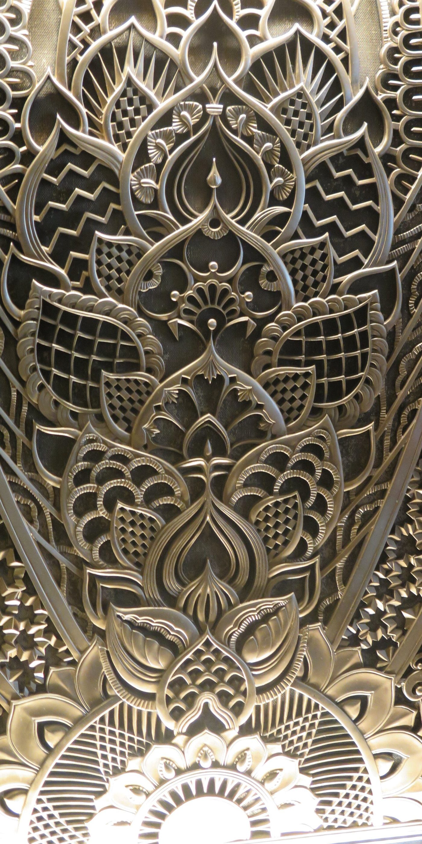 An ornate bronze lobby grille of woven foliage at the Chanin Building, New York