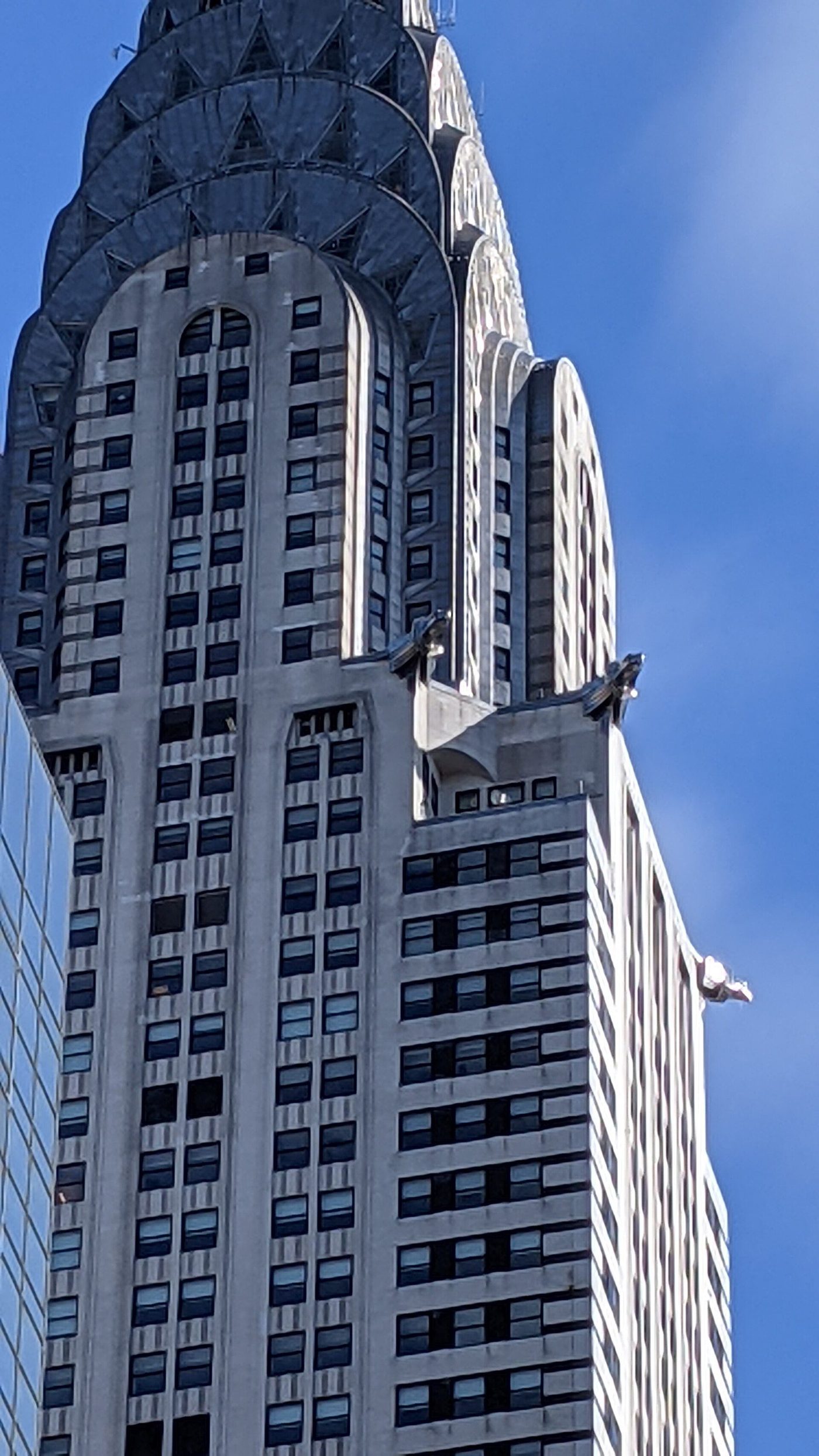 The Chrysler Building's upper shaft with one of its stainless-steel eagle gargoyles at the corner