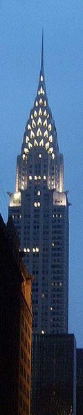 The Chrysler Building at dusk, its stainless-steel crown lit against the evening sky