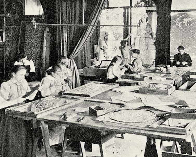 Women selecting and cutting stained glass at long tables in the Tiffany Studios glass room, in an 1894 engraving