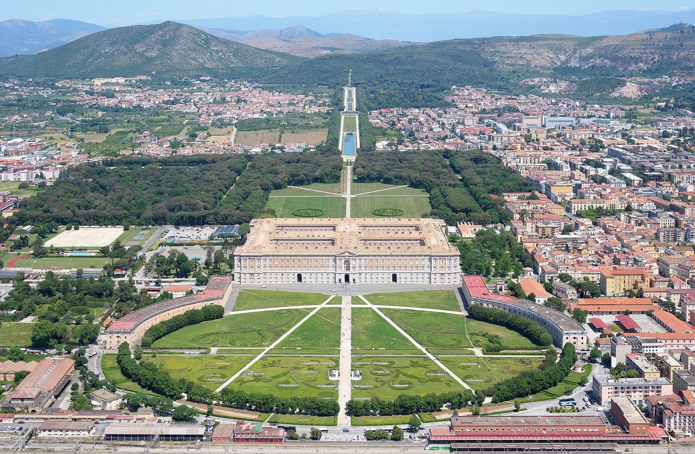 The Royal Palace of Caserta from the air, its park axis running to the great waterfall