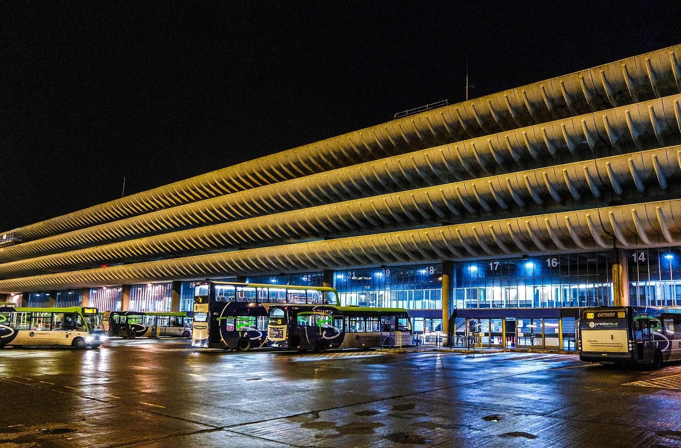 Preston Bus Station by night — the long curved concrete edge beams glowing