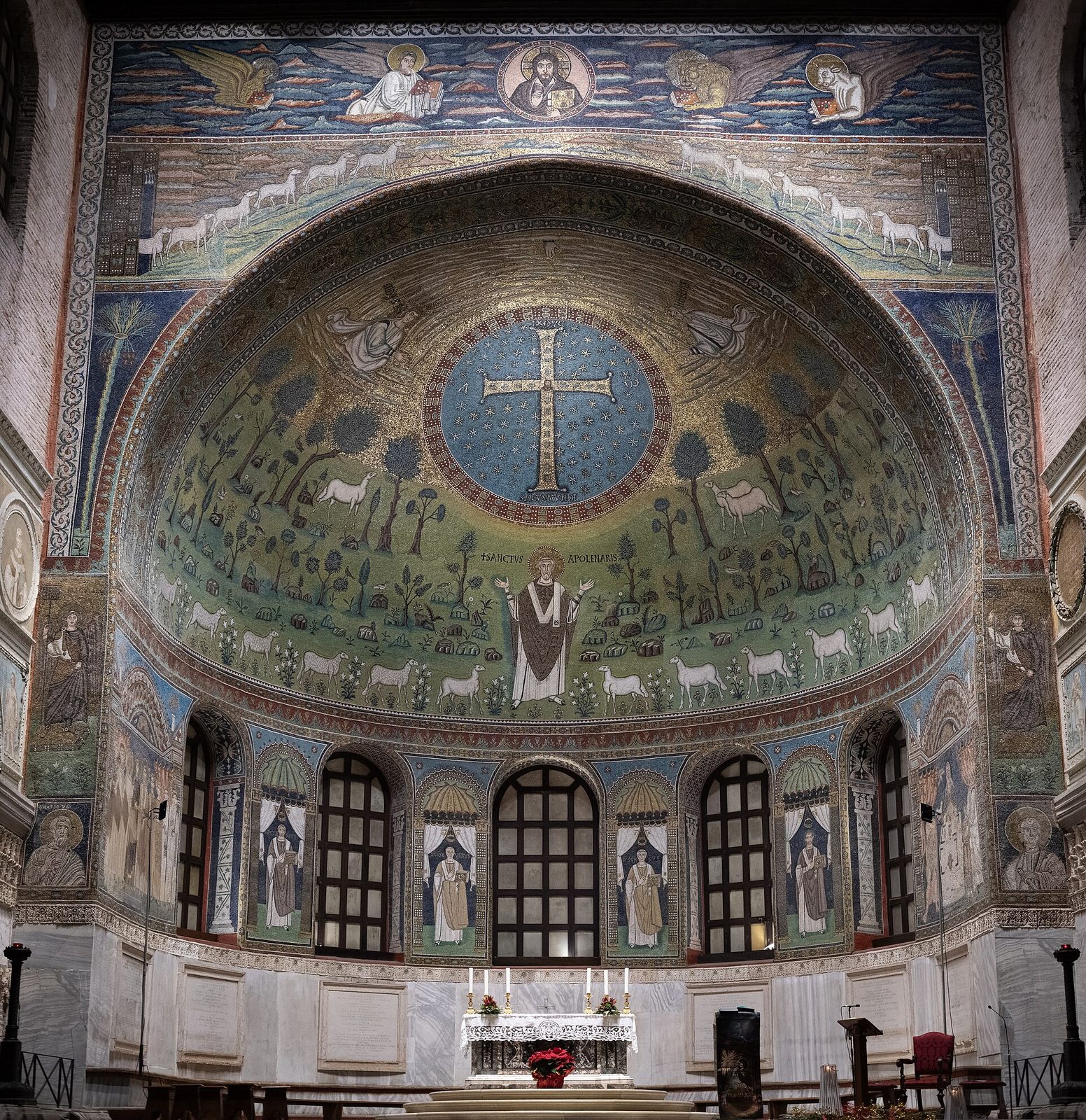 The apse of Sant'Apollinare in Classe: jewelled cross, St Apollinaris and lambs in a green paradise