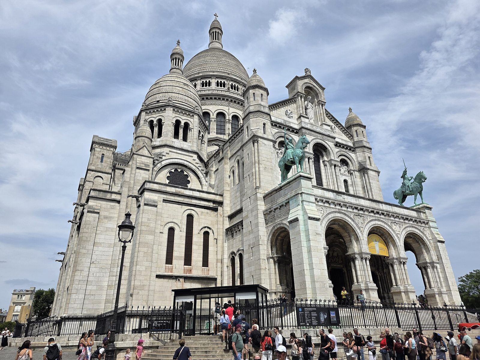 The Sacré-Cœur Basilica in Paris, white domes above its great steps