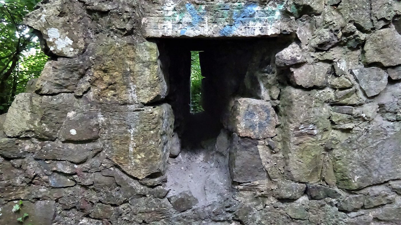 An arrow slit in the east wall of Ranfurly Castle keep: the narrow loop set in massive masonry