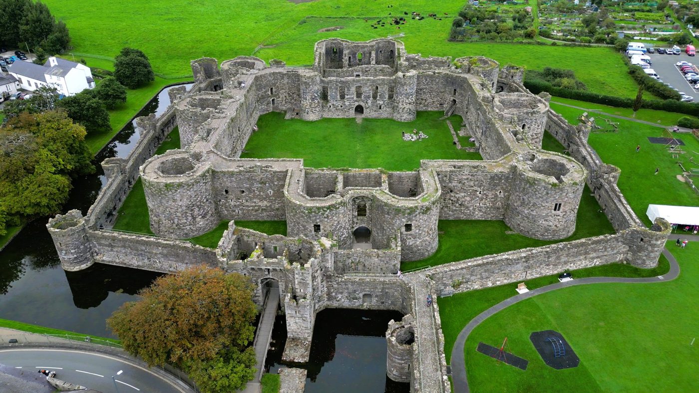 Beaumaris Castle from the air: the perfectly symmetrical concentric plan, an inner ward within a low outer curtain, its towers unfinished