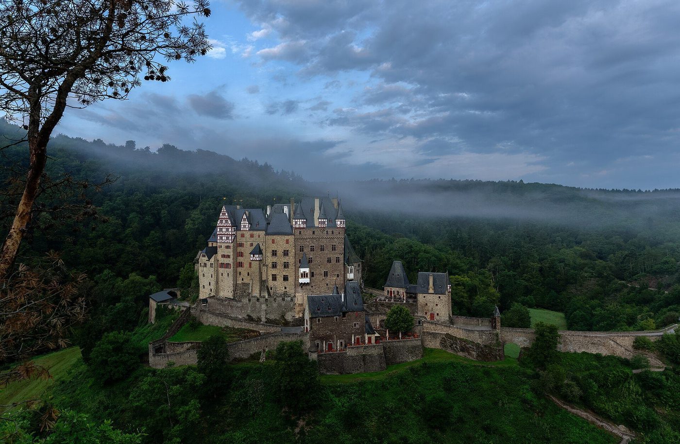 Burg Eltz in the early morning: the clustered towers and halls of the shared castle on their rock above the Elzbach valley