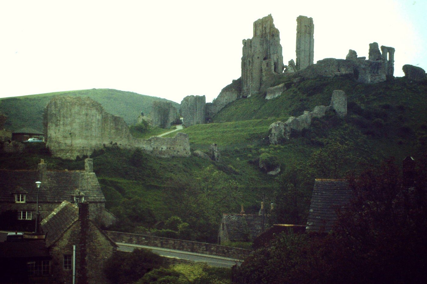 Corfe Castle ruins: the shattered keep and gatehouse on their hill above the village, slighted in 1646