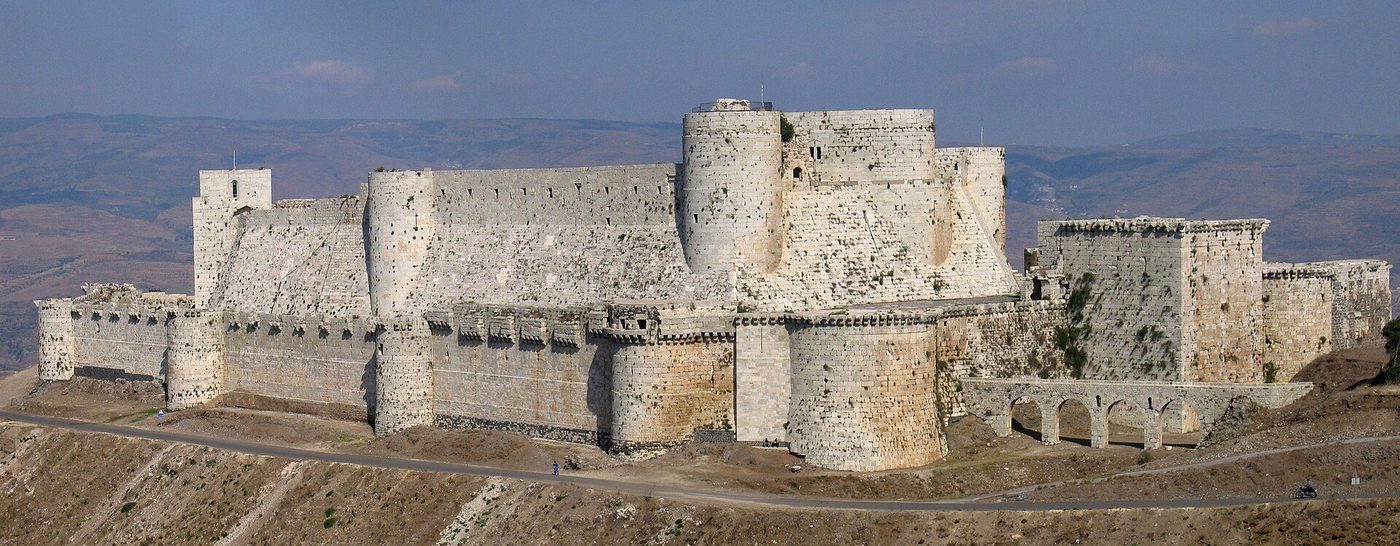 Krak des Chevaliers from the south: the great sloped glacis and the concentric walls rising tier on tier above it