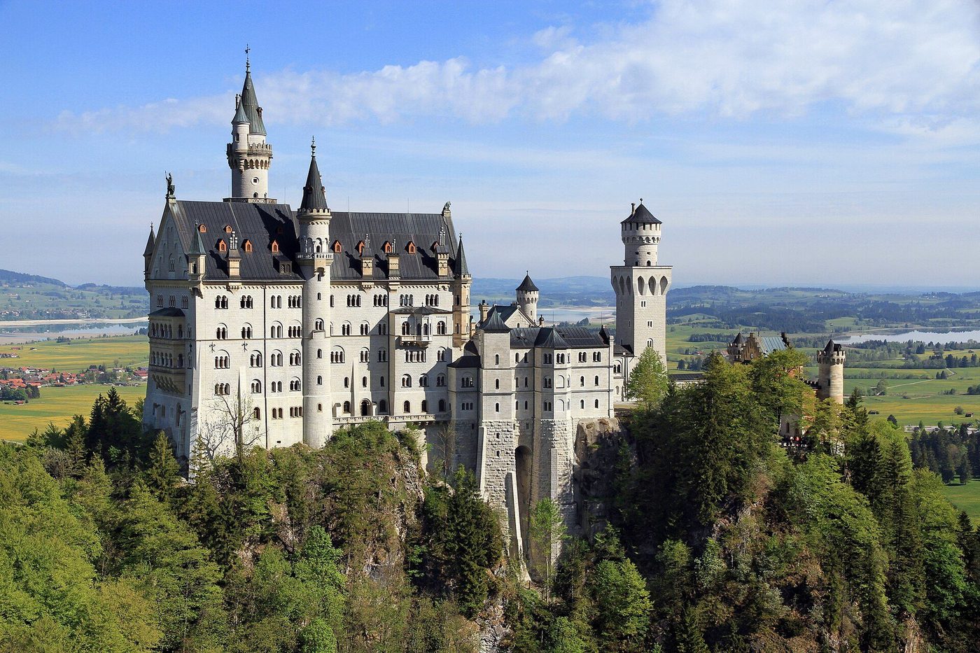 Neuschwanstein Castle from the Marienbrücke: white limestone walls and turrets above the Pollat gorge