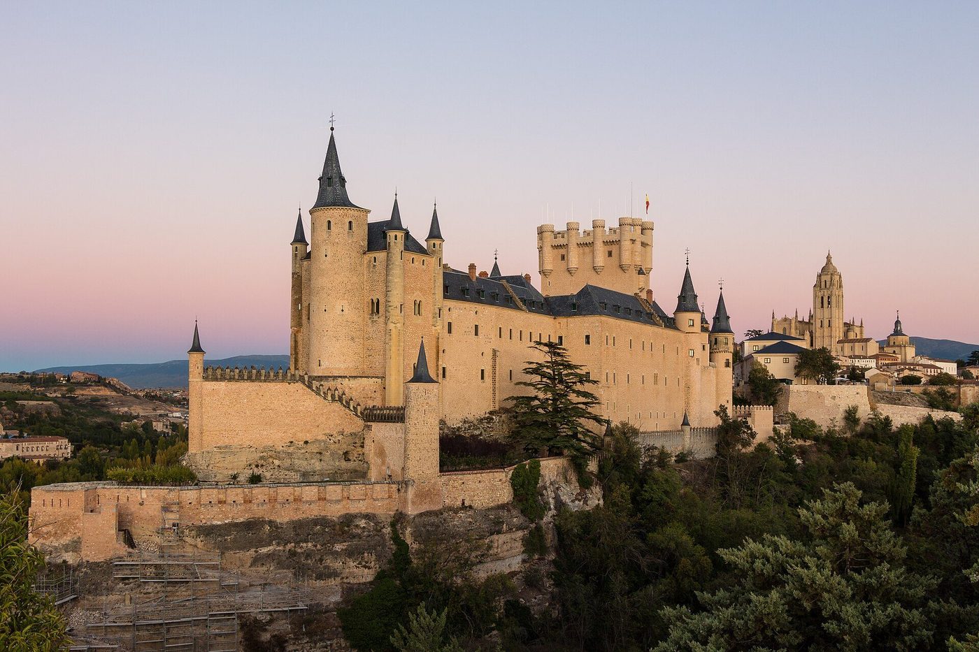 The Alcázar of Segovia: the fortress-palace on its rock above the plain, the slender Tower of John II rising over it