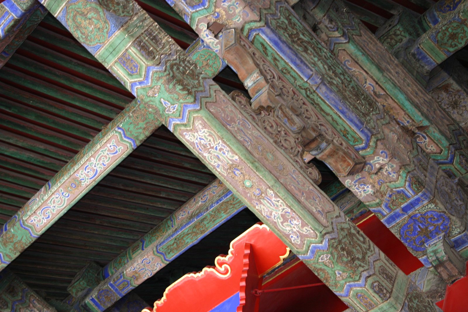 Interlocking painted dougong brackets inside a palace hall in the Forbidden City