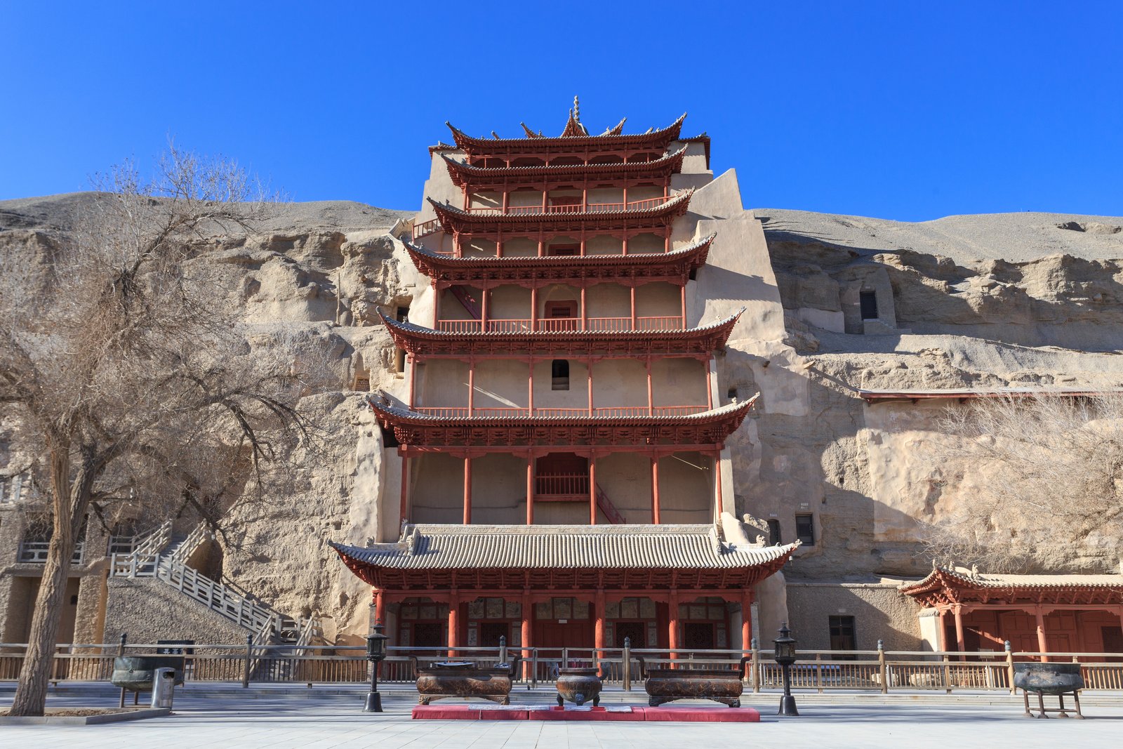 The cliff face at the Mogao Caves, Dunhuang, with the nine-storey temple tower fronting the grottoes