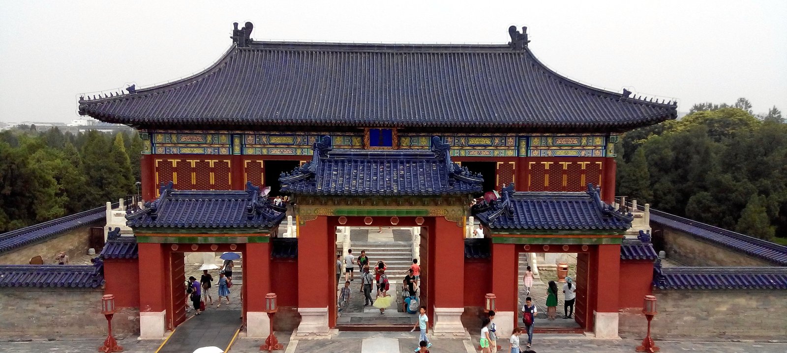 A broad blue-tiled roof with upturned eaves over red pillars at the Temple of Heaven, Beijing