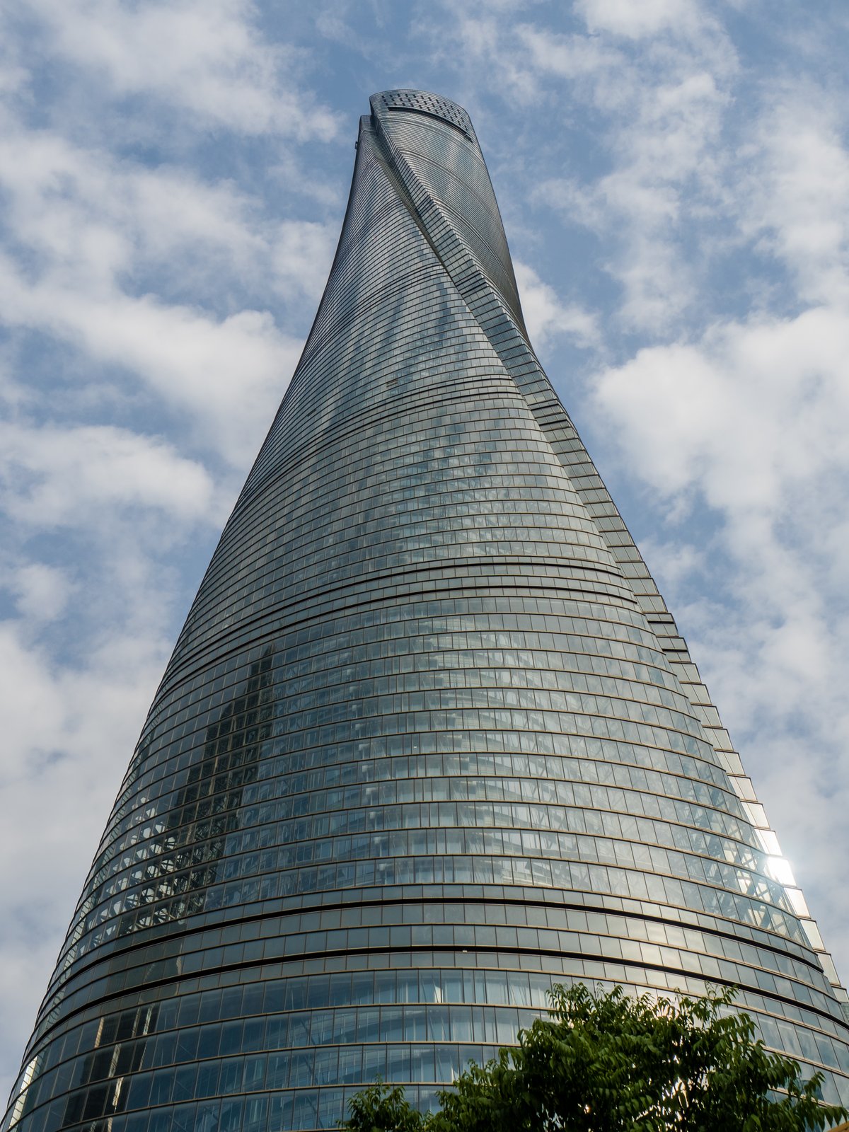 The Shanghai Tower in Lujiazui, its twisting glass form rising against the sky