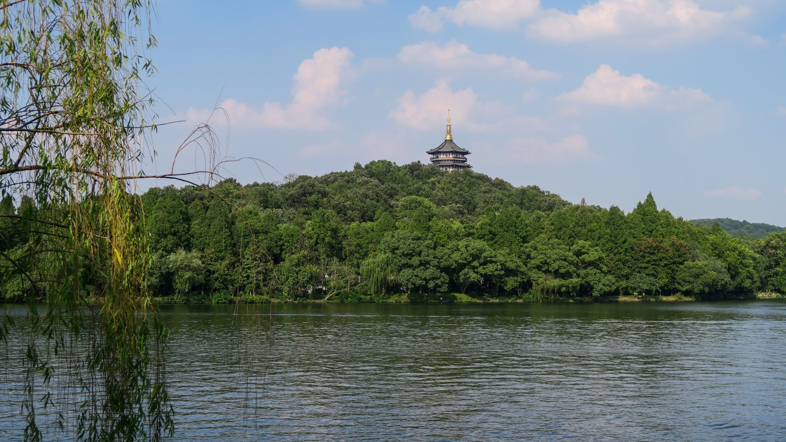 Leifeng Pagoda across West Lake, Hangzhou, framed by a willow tree