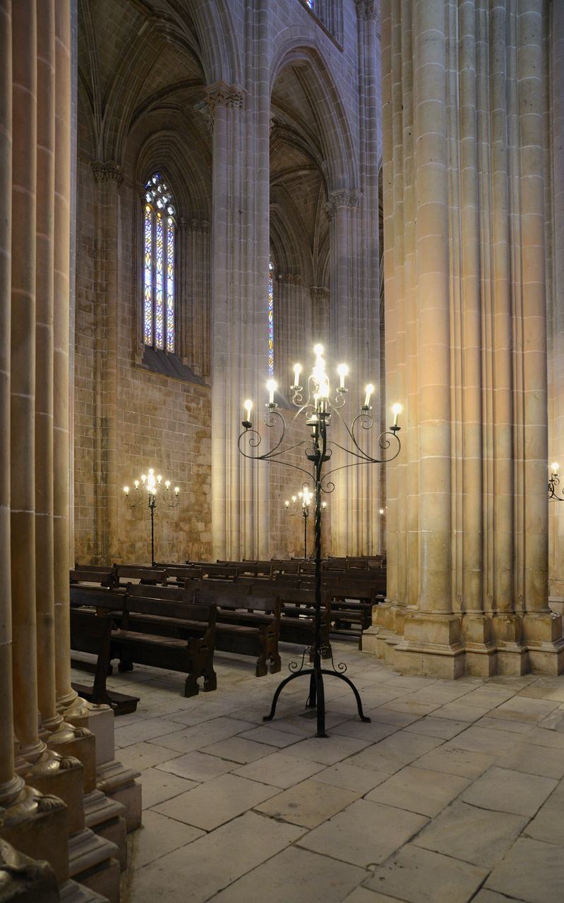 Inside the church of Batalha Monastery in Portugal, its tall Flamboyant nave piers