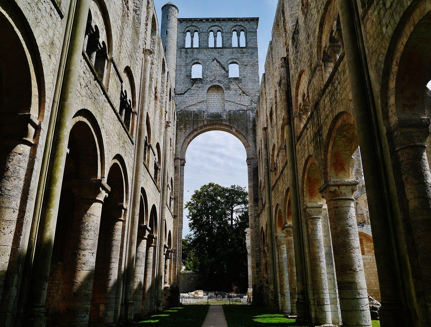 The ruined nave of Jumièges Abbey in Normandy, its Romanesque arcade open to the sky