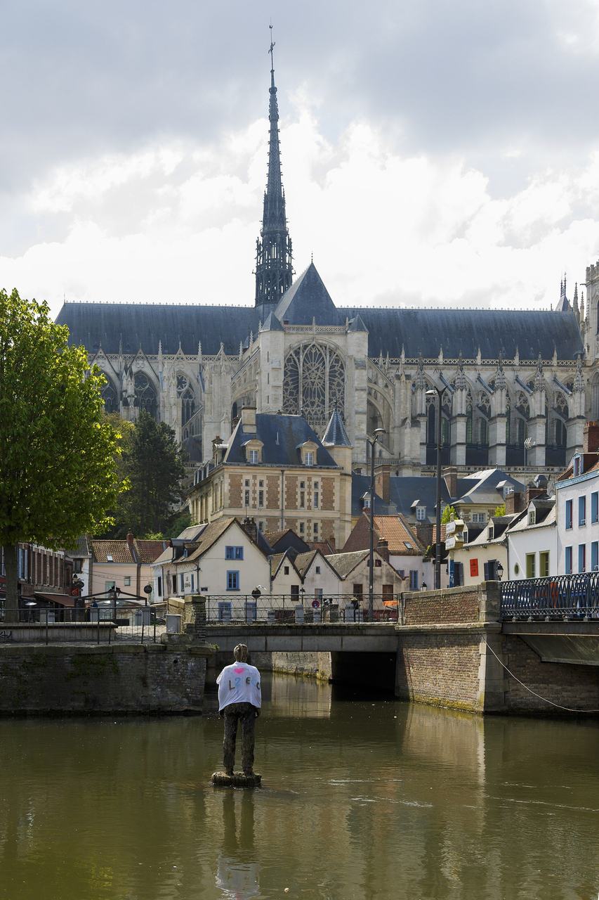 Amiens Cathedral rising above the Somme and the Saint-Leu quarter, its spire and chevet seen across the water