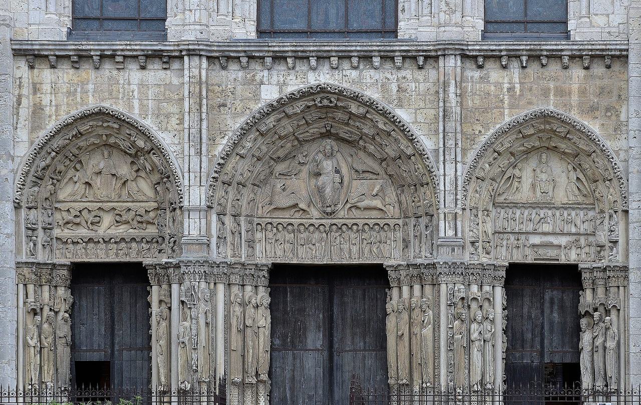 The three sculpted portals of the Royal Portal on the west front of Chartres Cathedral, with their column statues and carved tympana