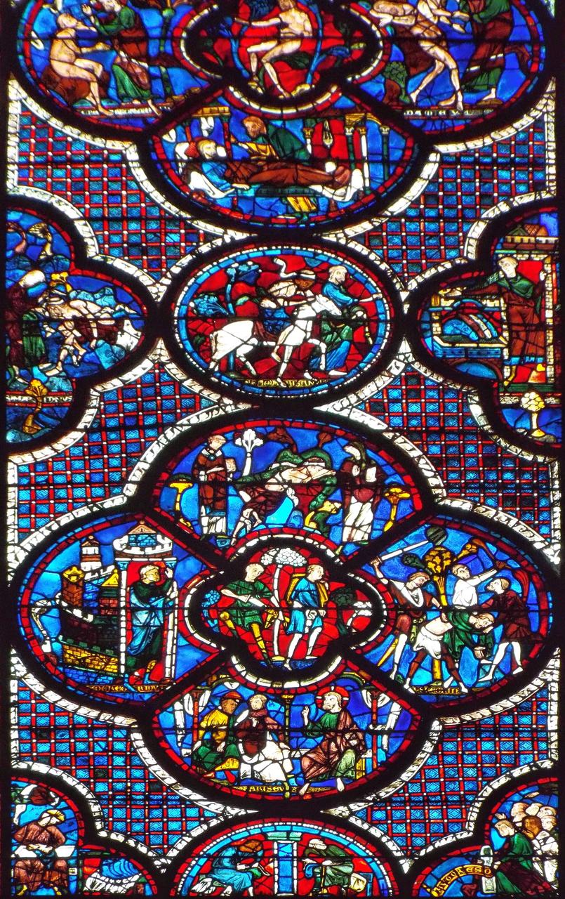 A stained-glass window at Chartres Cathedral with narrative medallions in deep blue glass