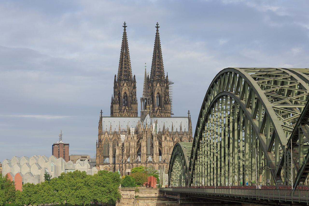 Cologne Cathedral from across the Rhine with the Hohenzollern Bridge: twin spires and the great five-aisled choir