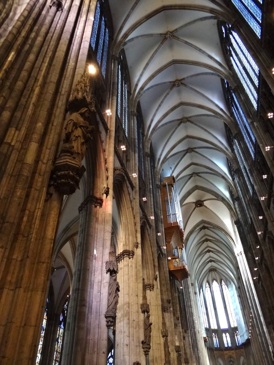 The interior of Cologne Cathedral: soaring French-modelled arcades, triforium and clerestory in grey stone