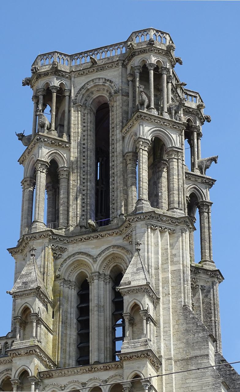 One of the openwork west towers of Laon Cathedral, its paired lancet openings carved with oxen at the angles