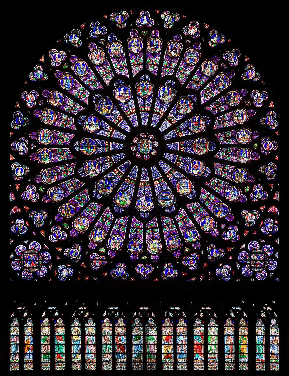 The north transept rose window of Notre-Dame de Paris seen from inside, a wheel of coloured glass