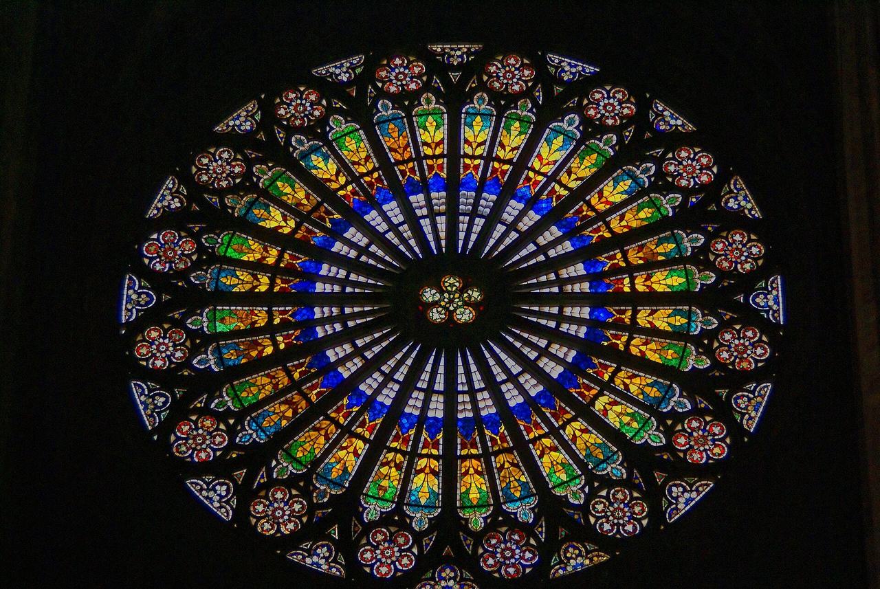 The rayonnant rose window of Strasbourg Cathedral's west front, seen against a black ground