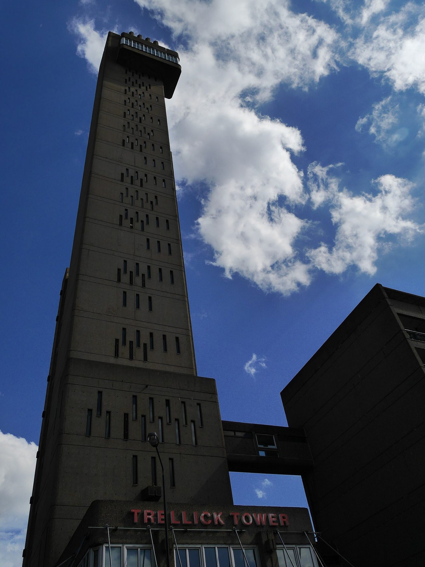 Trellick Tower, London — the slab and its separate service tower against the sky