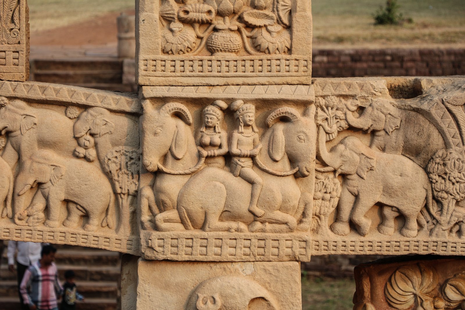 Carved figures and elephants on the East Torana gateway at Sanchi
