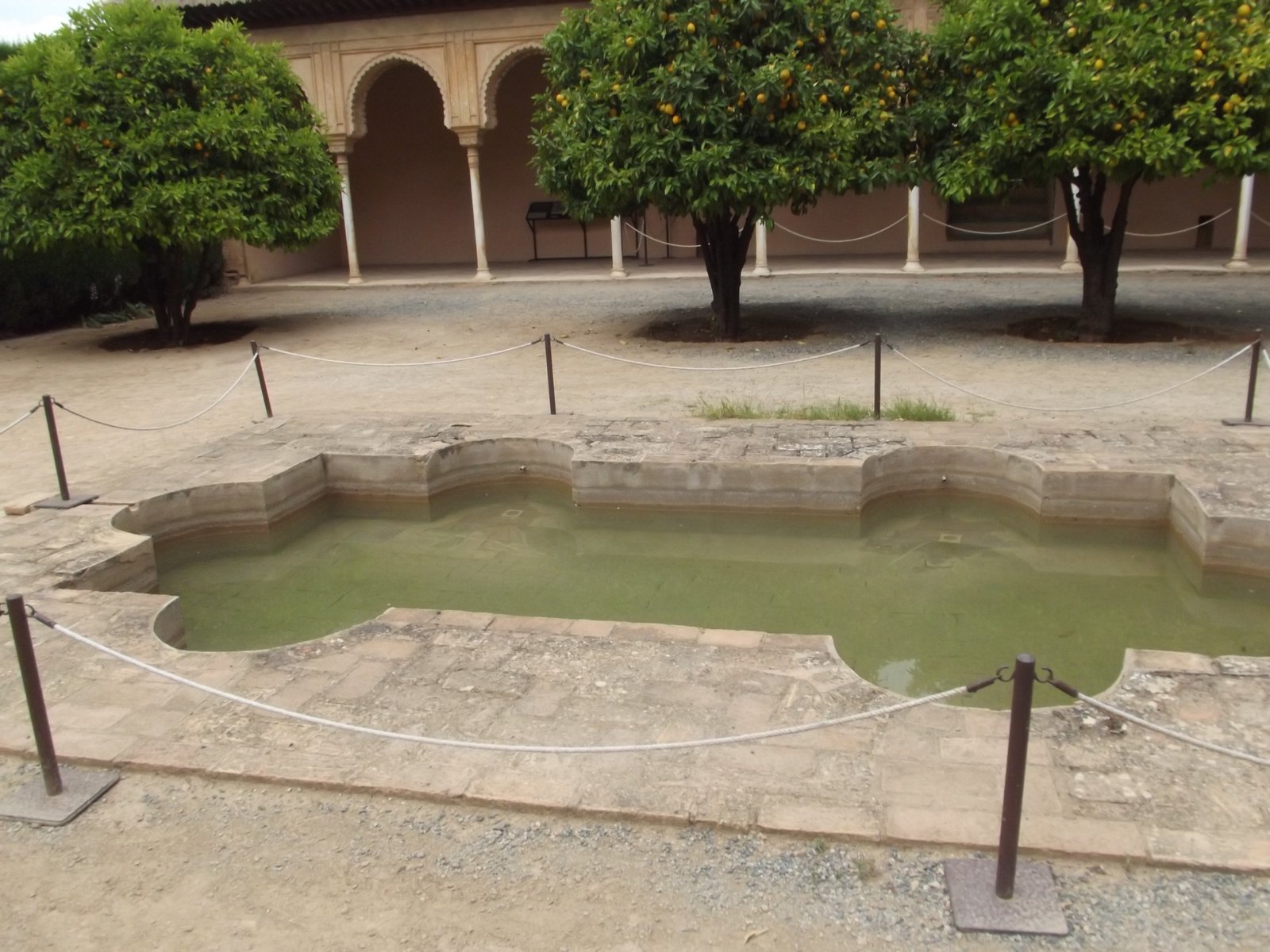 A Nasrid palace courtyard in the Alhambra, its arcades and carved plaster