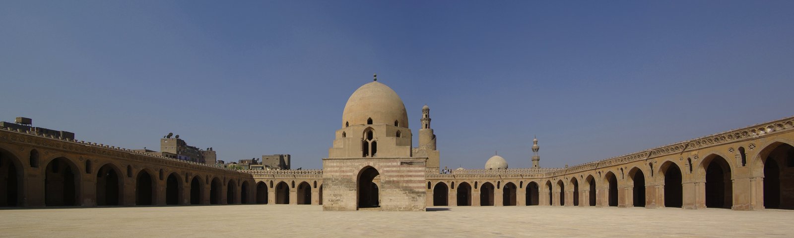 The courtyard arcades of the Mosque of Ibn Tulun in Cairo, its pointed arches on brick piers