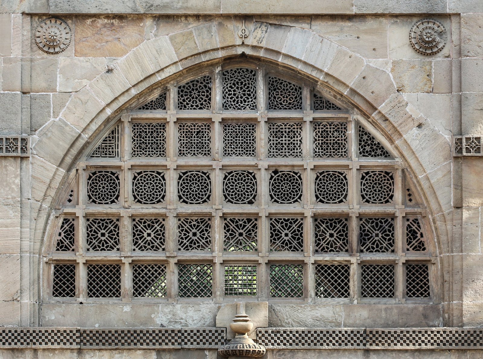 A pierced stone jali window of the Sidi Saiyyed Mosque in Ahmedabad, its tree-of-life carving