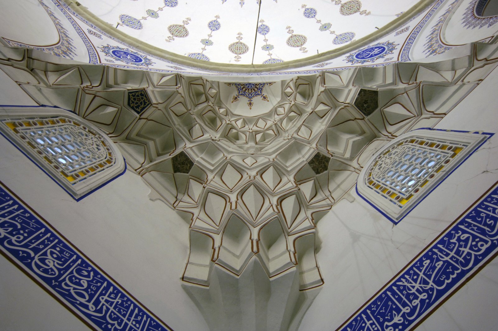 A dome over a mosque prayer hall, lit by windows at its base