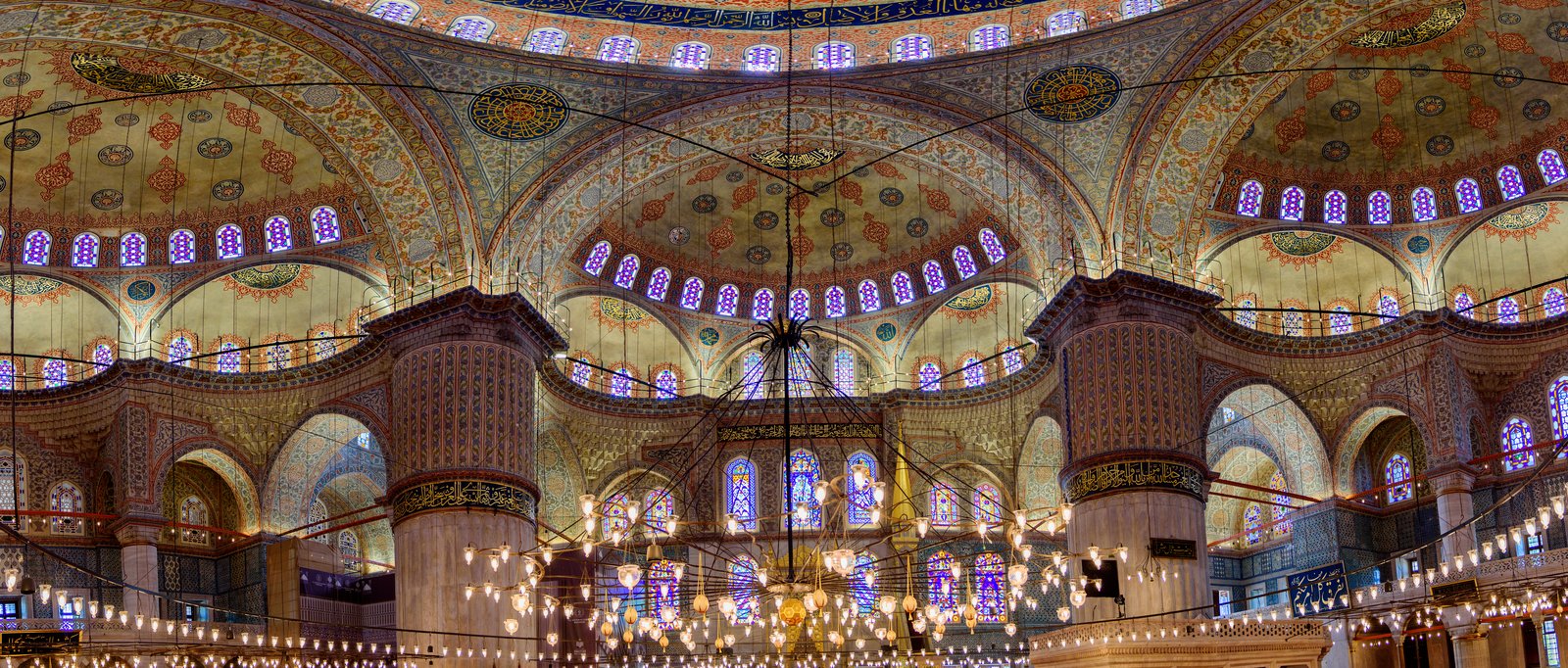 The interior of the Sultan Ahmed Mosque, its Iznik tiles and rows of windows