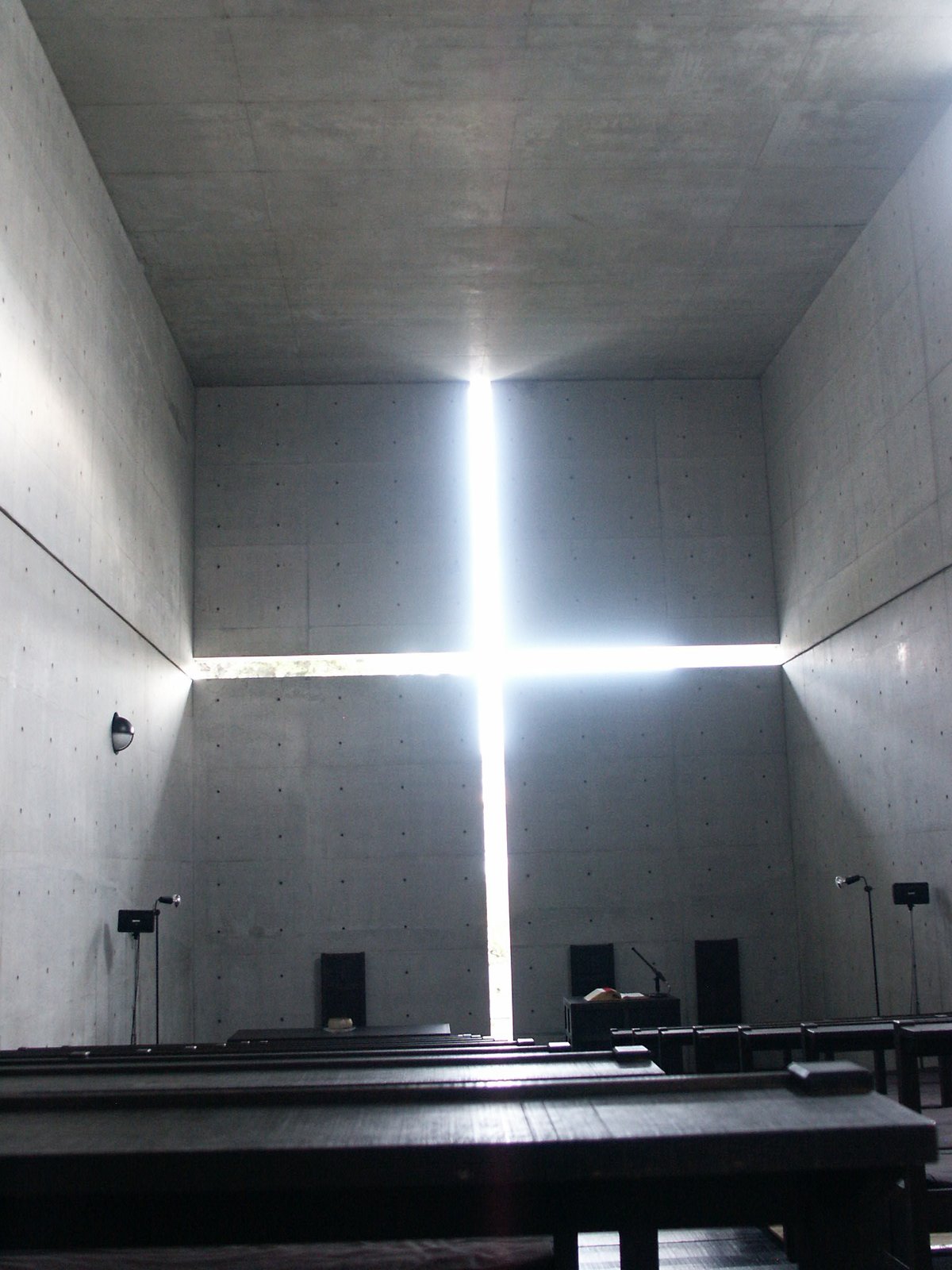 Inside the Church of the Light in Ibaraki, a cross of daylight cut into a concrete wall