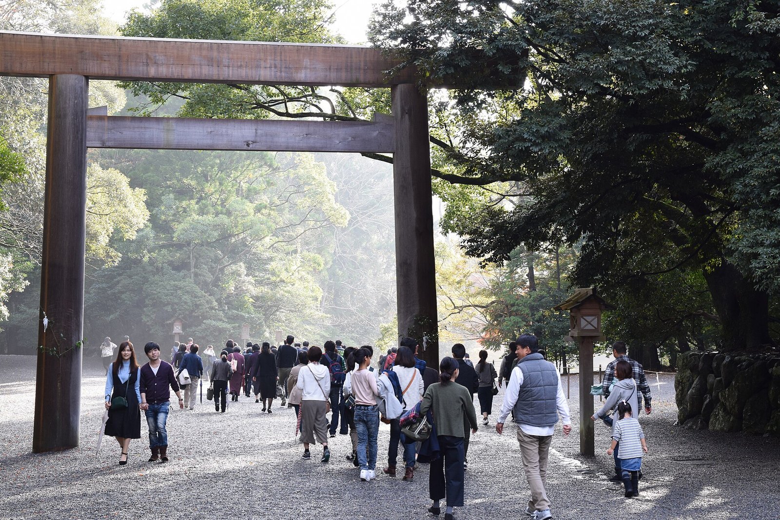 Visitors passing beneath the great wooden torii at the Grand Shrine of Ise