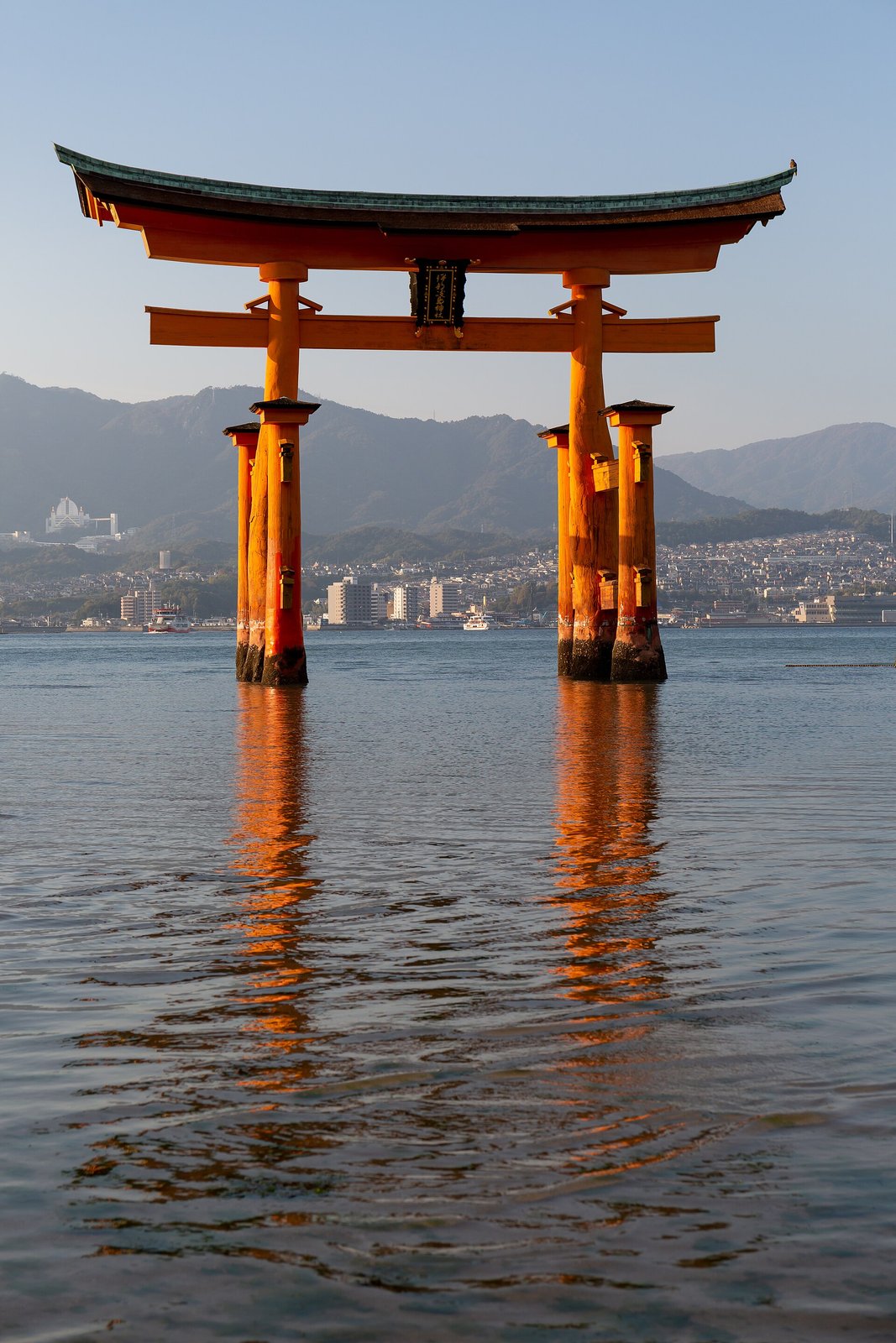 The great vermilion torii of Itsukushima Shrine standing in the sea at Miyajima