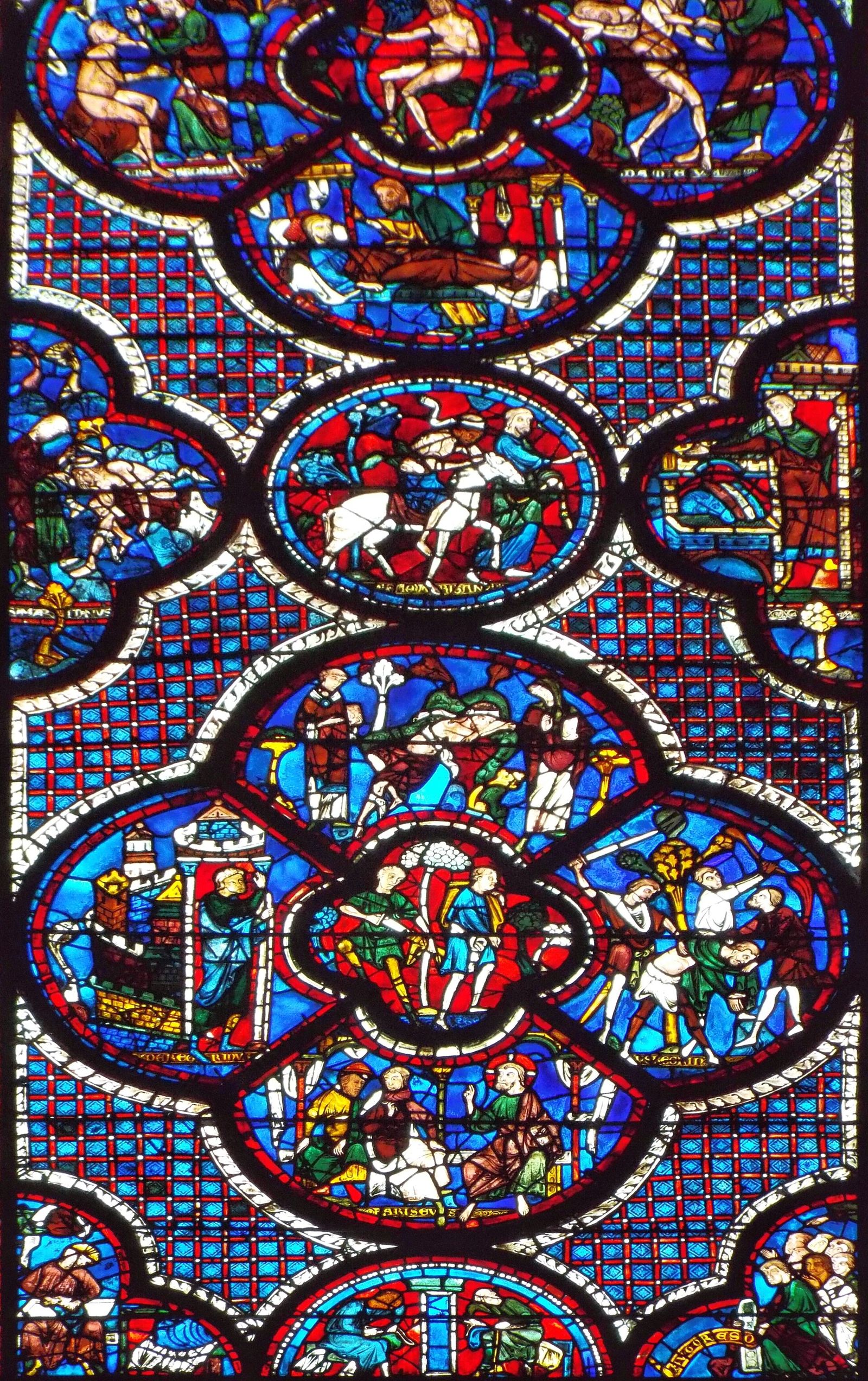 Detail of a medallion window at Chartres Cathedral, stained-glass scenes in roundels