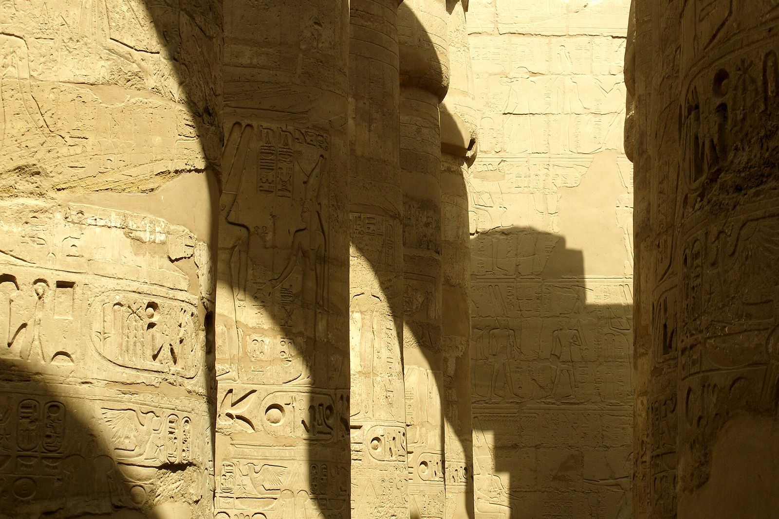 Carved columns of the Great Hypostyle Hall at Karnak in sun and shade