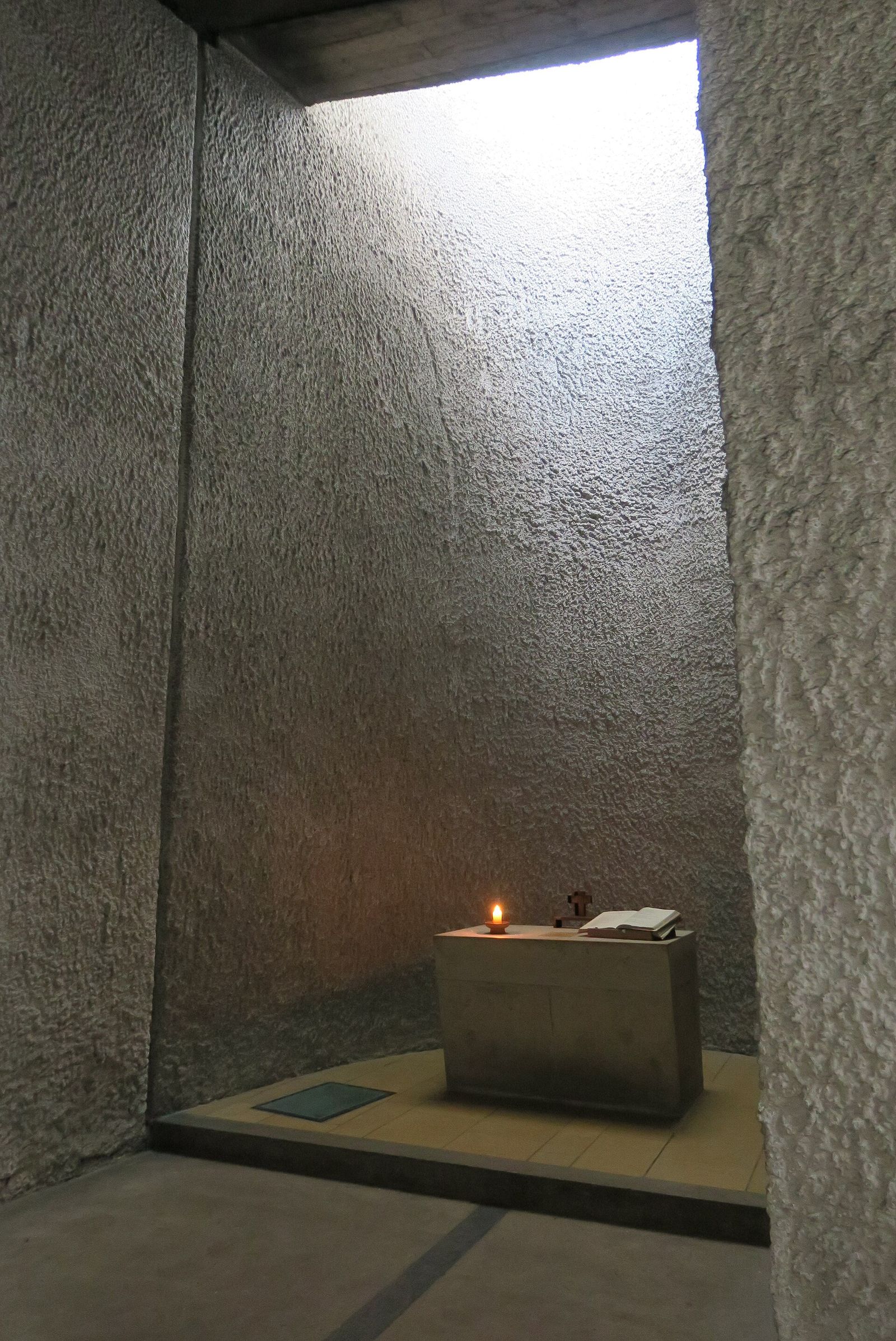 A side chapel of Notre Dame du Haut at Ronchamp, lit by a shaft of light from its tower