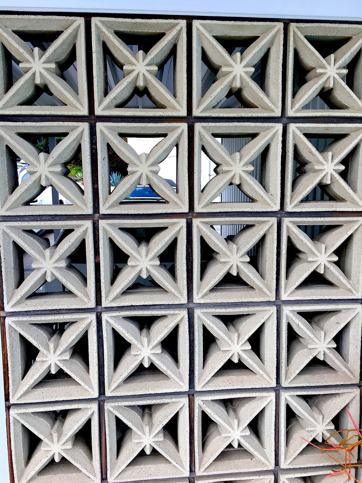 A decorative concrete block screen wall filtering light and air